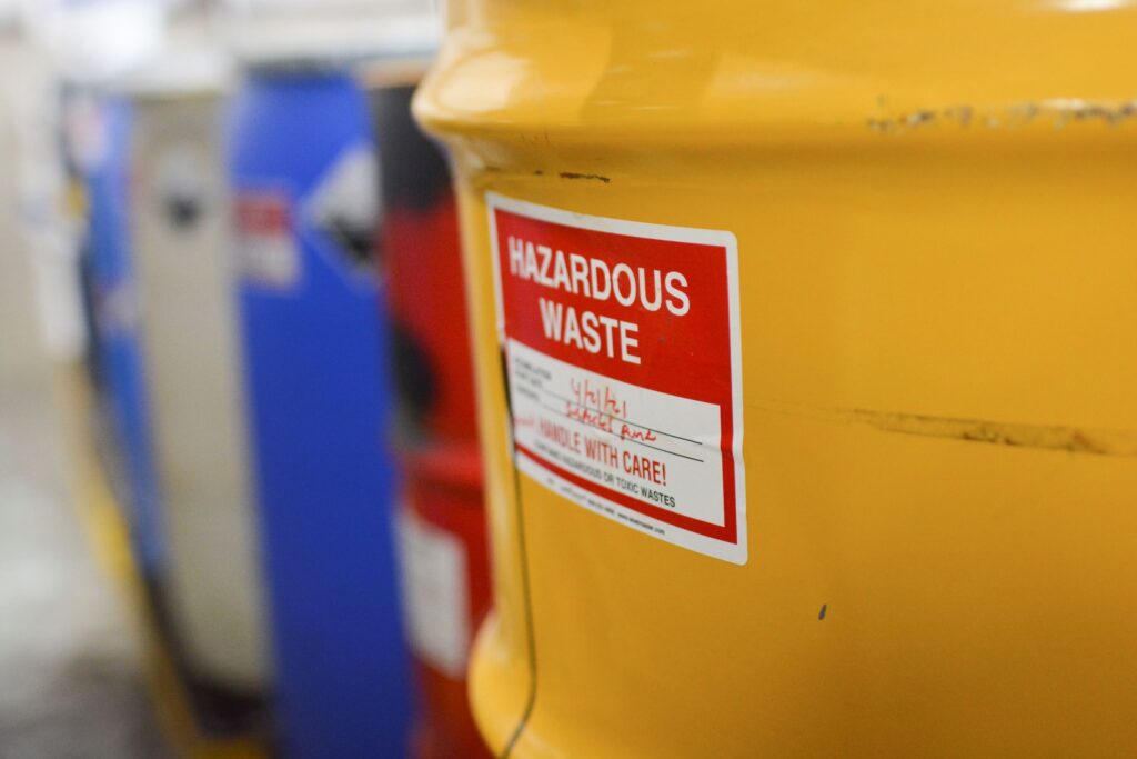A hazardous household waste barrel in yellow with appropriate labeling.