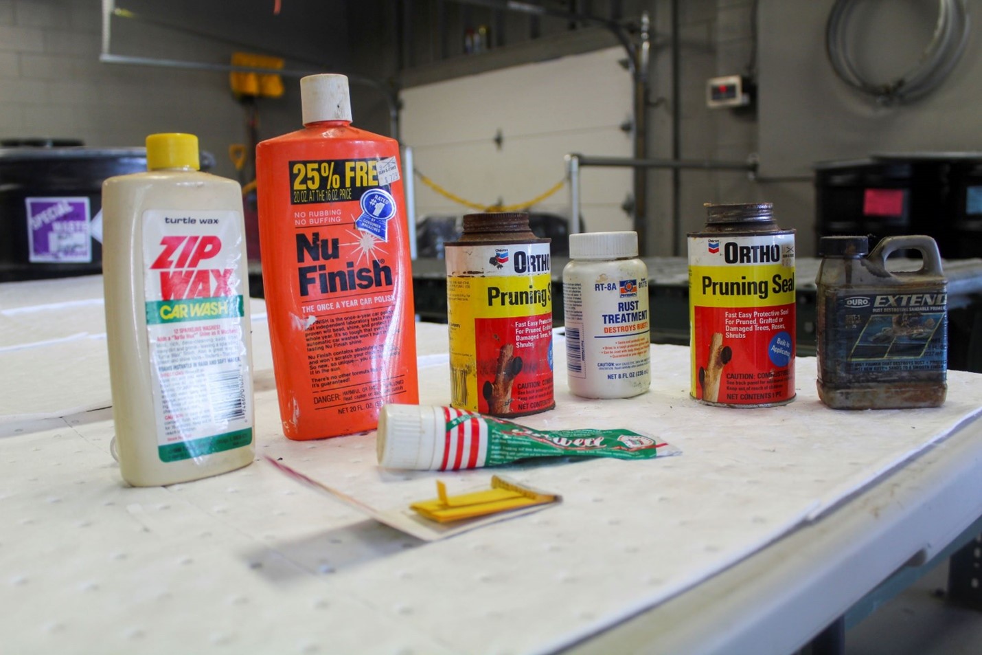 Bottles of waxes, sealants, and finishes lined up on a countertop
