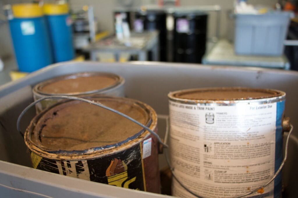 Latex paint cans at a NEDT collection center ready for disposal.