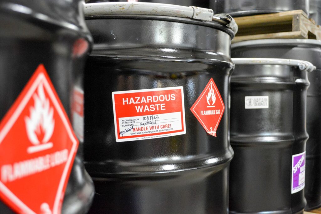 Various sealed drums of hazardous waste at an NEDT facility.