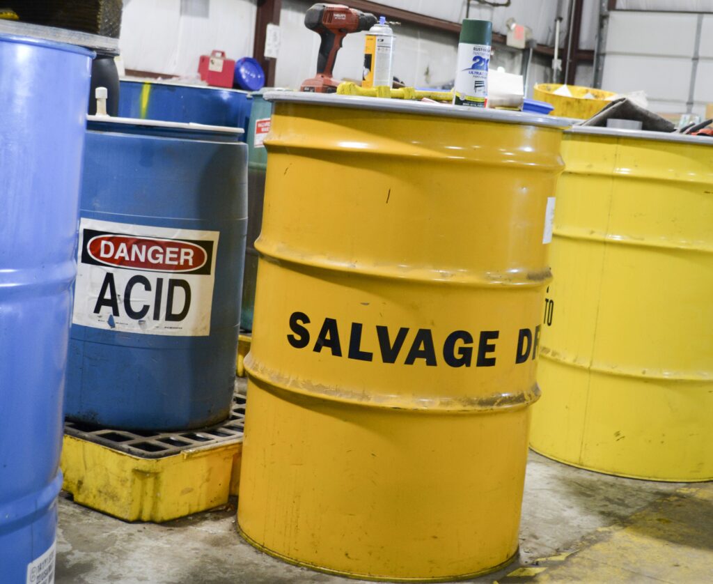 Various hazardous containers of chemicals and salvage waste.