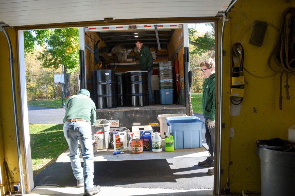 NEDT staff cleanout hazardous household waste from a garage during a home pick-up.