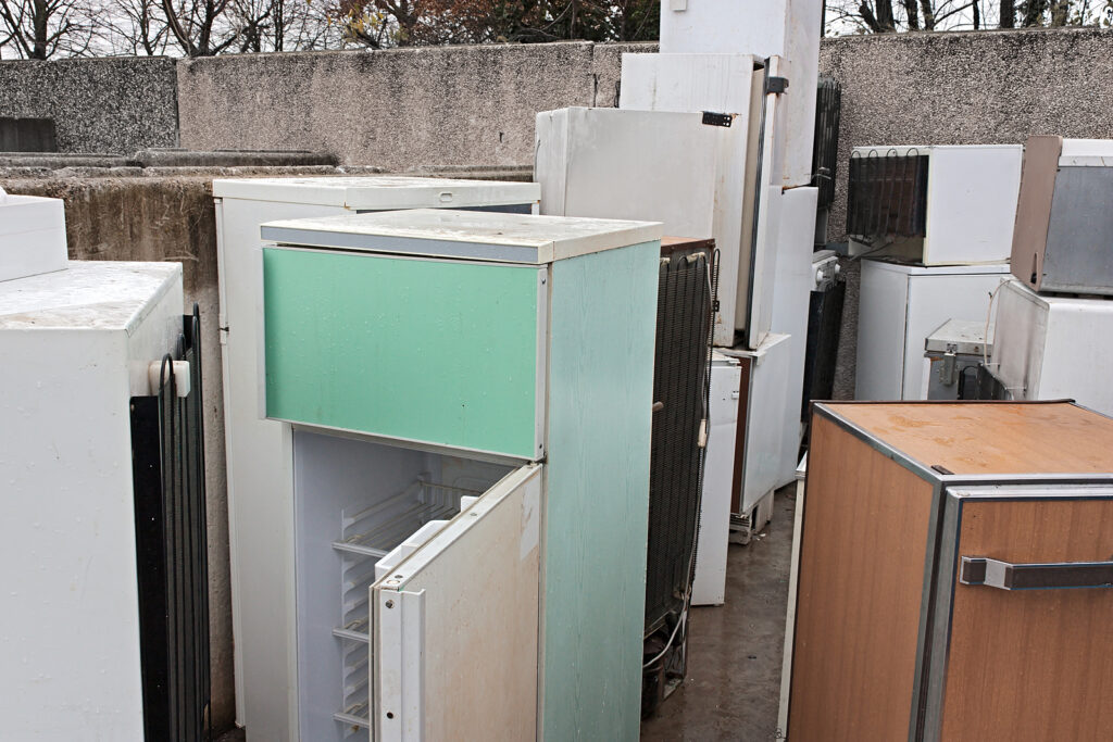 Various white good appliances, including old refrigerators and AC units.