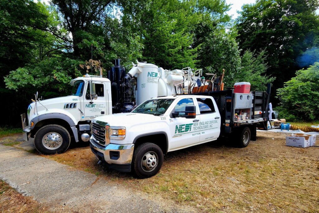 NEDT Vac Truck and other cleanup vehicles at a home furnace oil spill.