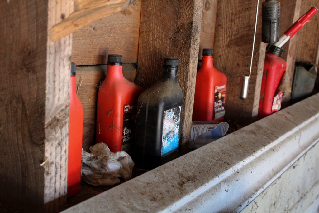 Various types of automotive fluids sitting in garage storage.